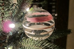 This glass ornament from the WWII years had no metal, only red and white stripes, faded and worn, and well loved.
